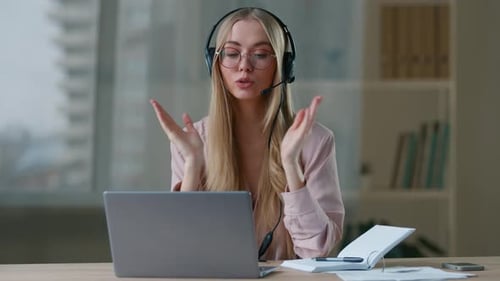 Blonde Woman with Headset Video Conference at Desk