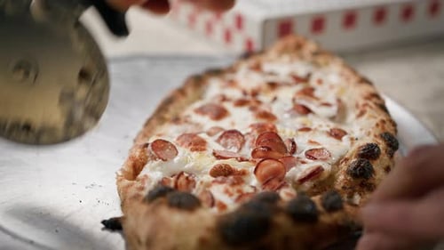 Close-up of a small pepperoni pizza in a restaurant kitchen