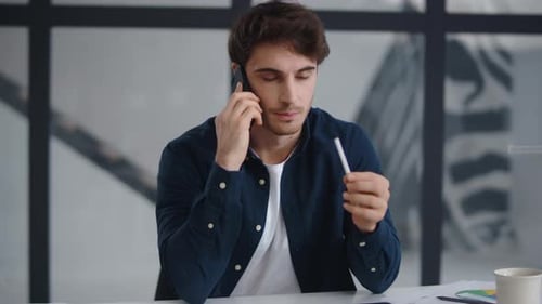 Closeup Focused Businessman Talking Mobile Phone in Home Office. Busy Man Explaining
