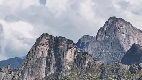 Majestic Mountain Peaks Under a Cloudy Sky