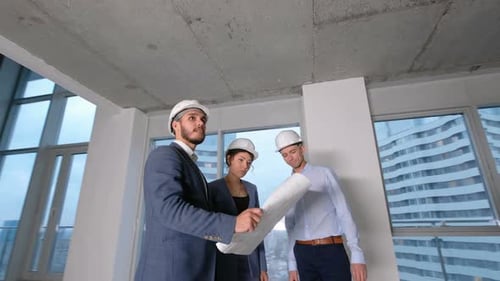 Group of Construction Workers Checking Building