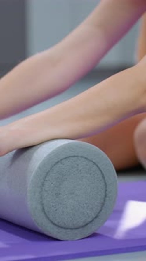 Flexibility Workout with Foam Roller and Fitness Ball in Gym