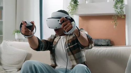 Man Plays VR Game Using Headset and Controllers