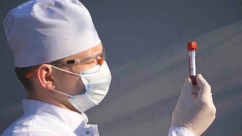 Medical Professional Analyzing Blood Sample in Test Tube