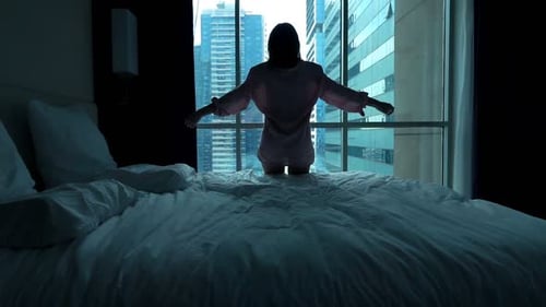 Woman in Hotel Room Spreads Arms to View