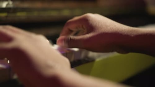 Hands Playing the Piano Keys