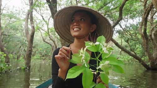 Woman Boating Through Tropical Forest River