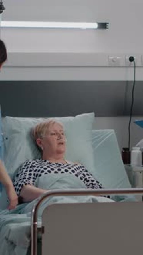 Elderly Patient Receives Care in Hospital Bed