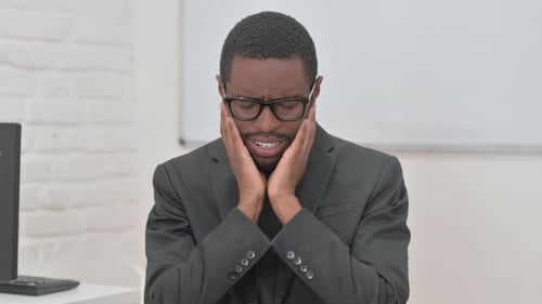 Bewildered Young African Businessman Expressing Confusion