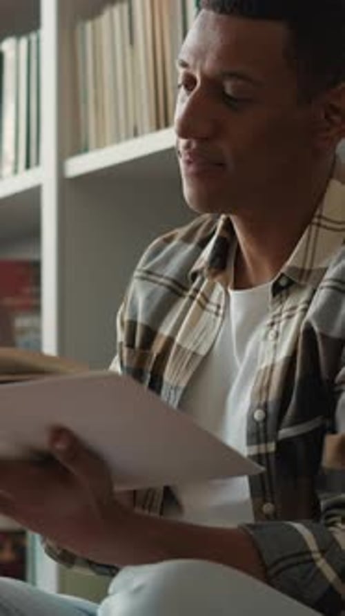 Calm African American Man Student Reading Book Sitting on Library Flor Bookshelves Ethnic Male Guy