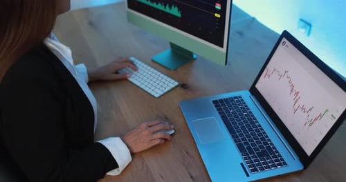 Mature business woman researching bitcoin price trends at fintech company office in USA