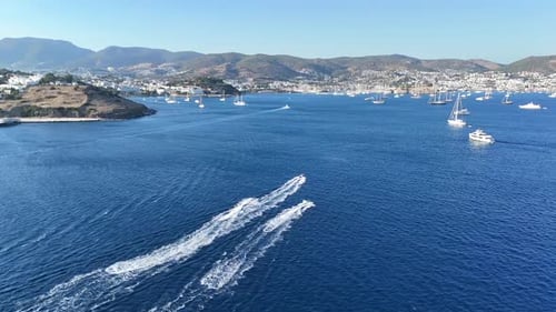 Aerial View of Sailboats and Jet Skis on Coast