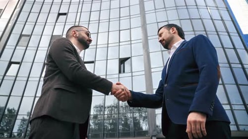 Business Male Partner Hand Shaking Friendly Greeting Deal Agreement at Downtown Office Skyscraper