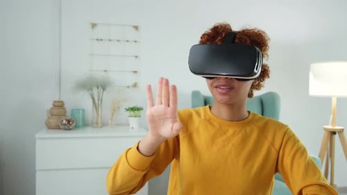 Woman Interacts With Virtual Reality Headset at Home