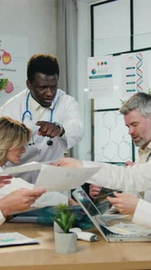 Medical Professionals Discussing X-rays in Bright Office Setting
