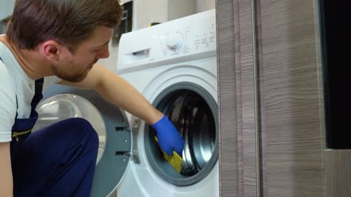 Young Adult Cleaning Washing Machine with Sponge