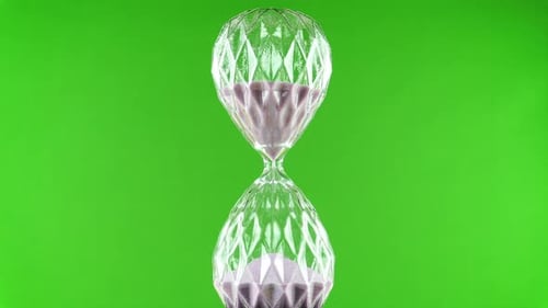 Rotating Hourglass Flask On A Green Background.