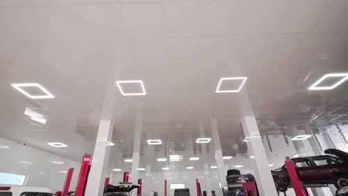 Modern Vehicle Maintenance Shop with Bright Lighting Clean Facilities Technicians Service Cars