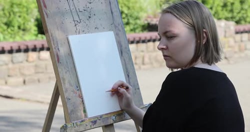 The young woman sketching a floral composition with a pencil