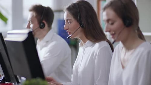Close Up Young People Woman Man Operator Taking Calls Use Computer Smile in Call Center Office