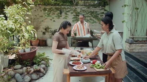Friends Enjoying Backyard Barbecue on Sunny Day