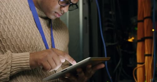 Young Adult Using Tablet in Server Room