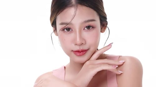 Close up portrait beautiful young Asian woman with healthy facial skin over white background.