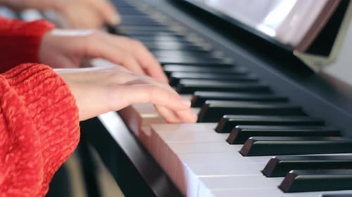 Woman Playing Piano Keyboard Indoors Close Up