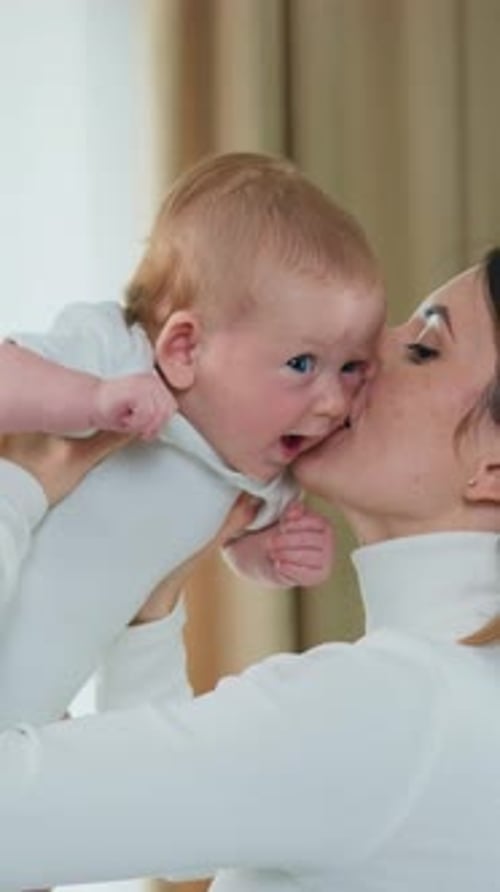 Loving mother holding her adorable baby close up