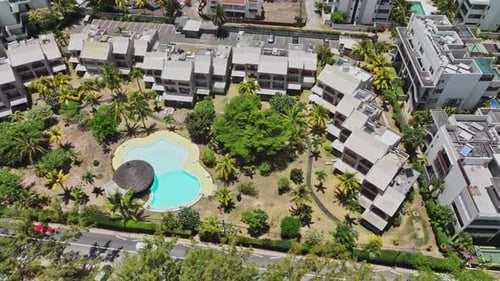 An aerial view of an apartment complex with a swimming pool