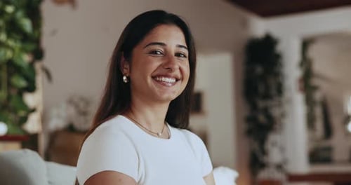Smiling Young Woman with Long Dark Hair Indoors