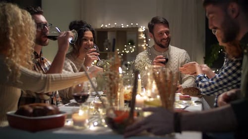 Friends Enjoy Dinner Party with Wine and Candles