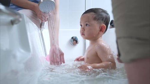 Adorable Baby Taking Bath in White Tub