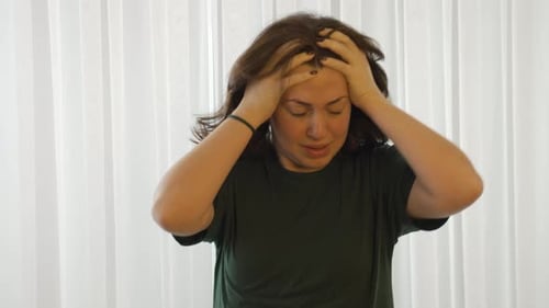 Woman Touches Head and Neck