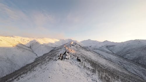 Snowy Mountain Range Aerial at Sunrise