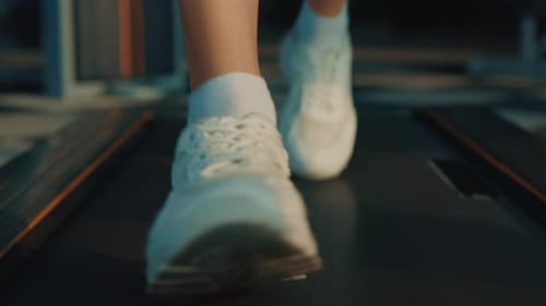 Sportswoman in White Sneakers Runs on Treadmill in Gym Close Up