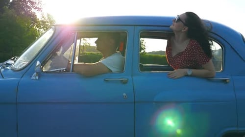 Carefree Couple Driving Vintage Car on Country Road