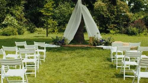 Wedding Ceremony Setup with Flowers in a Forest