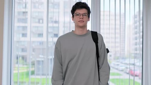 Portrait of College Student Guy Looking at Camera Inside Window at Classroom