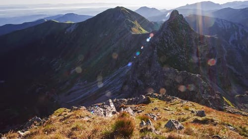 Panoramic Shot of Alpine Rocky Peaks in the Morning Rays of the Sun