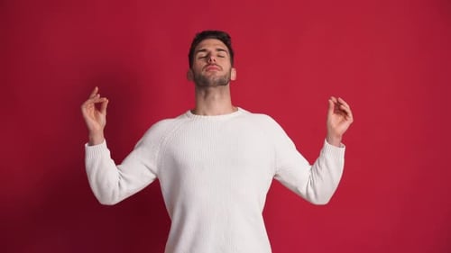 Confident Black Man with Raised Hands Doing Meditation
