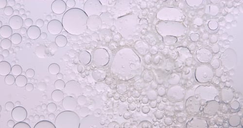 Macro Clear Oil Bubbles in Water Fluid Motion Background
