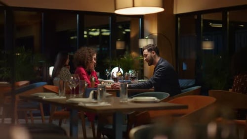 Elegant couple enjoying romantic evening date at luxury restaurant in fancy hotel