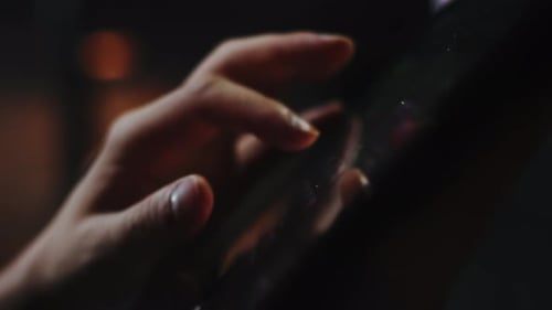 Closeup of the Sound Engineer's Hands Adjusting Equalizer Sliders on the Tablet During the Show