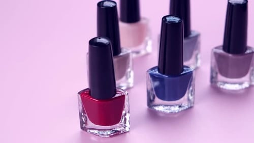 Colorful Nail Polish Bottles on Pink Surface