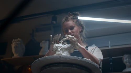 Young Artist Sculpting Clay in Her Studio
