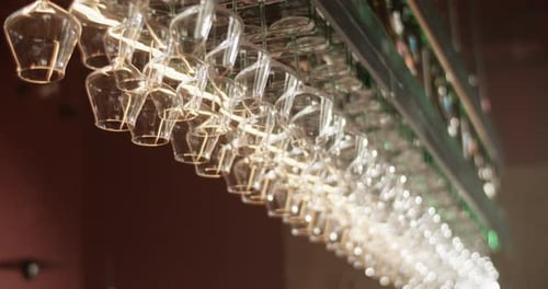 Wine Glasses Hanging on Rack in Bar