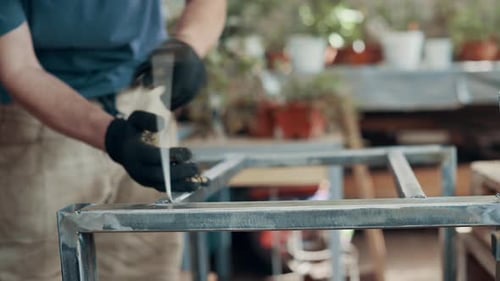 Metalworker Welding Steel Frame in Workshop