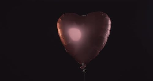 Aluminum Foil Helium Pink Ballon In Black Background. - close up