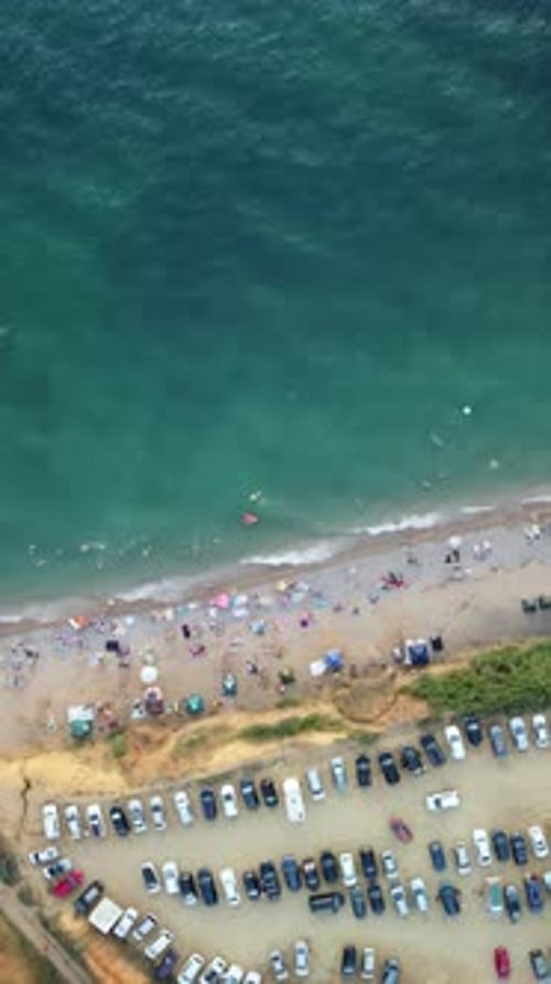 Aerial View of Sandy Beach Swimming People in Sea Bay with Transparent Blue Water at Sunset in